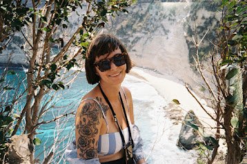 Anuša among trees above a turquoise bay
