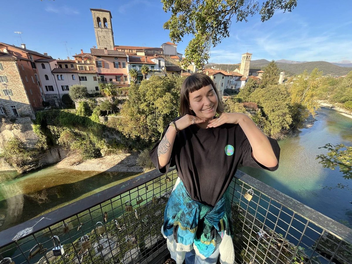 Anuša laughing above the river in Cividale
